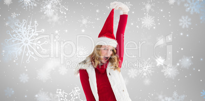 Composite image of cheering woman in santa hat