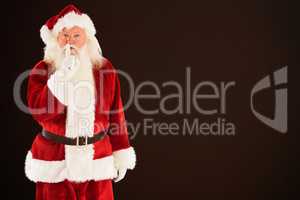 Composite image of santa asking for quiet to camera