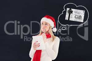 Composite image of festive blonde writing her christmas list
