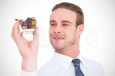 Composite image of happy businessman holding his hand up
