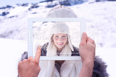 Composite image of hand holding tablet pc