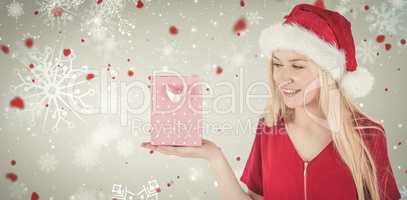 Composite image of festive blonde holding a gift bag