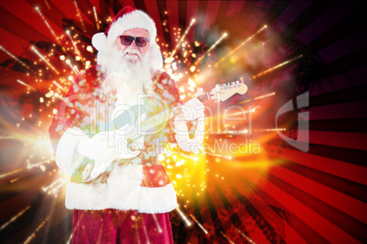 Composite image of santa claus plays guitar with sunglasses