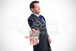 Composite image of businessman holding out his hands to the came