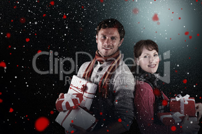 Composite image of couple holding lots of presents