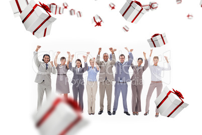 Composite image of happy business team raising their arms