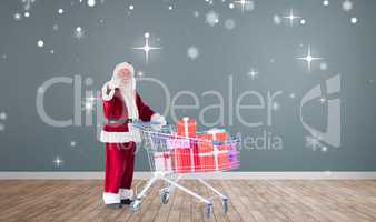 Composite image of santa pushing a shopping cart