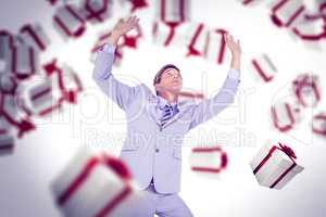 Composite image of scared businessman with hands raised