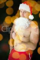 Composite image of smiling muscular man posing in sexy santa out