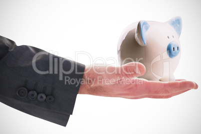 Composite image of businessman holding hand out in presentation