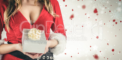 Composite image of sexy santa girl holding gift