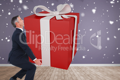 Composite image of stylish man with giant gift