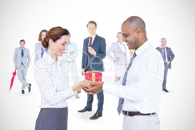 Composite image of business colleagues holding plant together