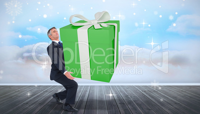 Composite image of stylish man with giant gift