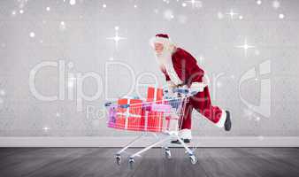 Composite image of santa pushing a shopping cart