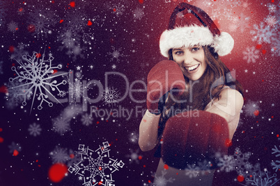 Composite image of festive redhead punching with boxing gloves