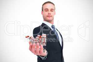 Composite image of serious businessman holding out his hand