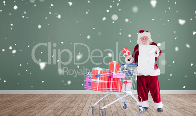 Composite image of santa delivering gifts from cart