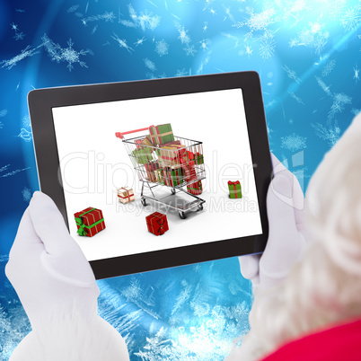 Composite image of santa claus using tablet pc