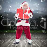 Composite image of santa carrying gifts