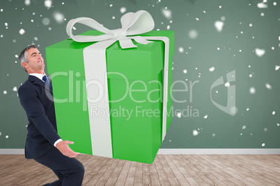 Composite image of stylish man with giant gift