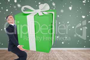 Composite image of stylish man with giant gift