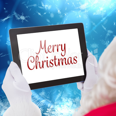 Composite image of santa claus using tablet pc Composite image of santa claus using tablet pc