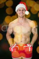 Composite image of smiling muscular man posing in sexy santa out