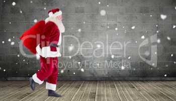 Composite image of santa carrying sack of gifts