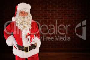 Composite image of happy santa claus holding a gift