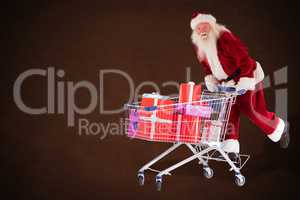 Composite image of santa rides on a shopping cart