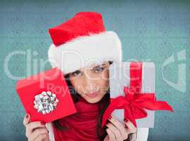 Composite image of cheerful brunette holding christmas gifts