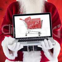 Composite image of santa claus presents a laptop
