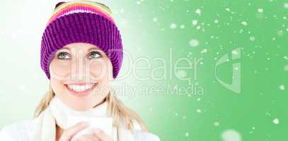Composite image of smiling woman with a colorful hat and a cup i