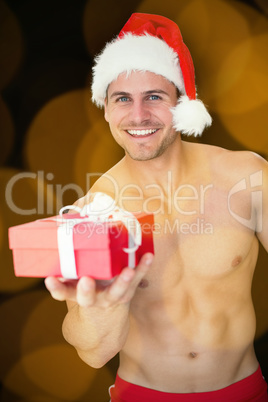 Composite image of smiling muscular man posing in sexy santa out