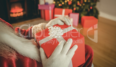 Santa claus holding a red gift