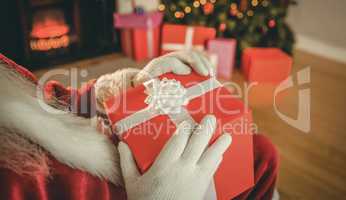 Santa claus holding a red gift