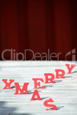 Christmas Card With Red Letters Merry Xmas On White Wood