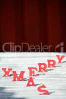 Christmas Card With Red Letters Merry Xmas On White Wood