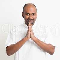 Mature casual business Indian man praying