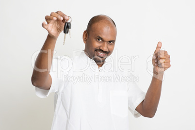 Mature Indian man holding car key and thumb up