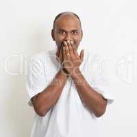 Mature casual business Indian man covered mouth