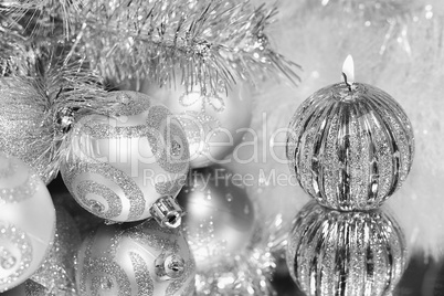 Christmas decorations with candle and silver balls.