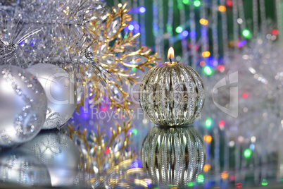 Christmas decorations with candle and silver balls.