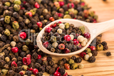 Pepper seeds in wooden spoon on wood table