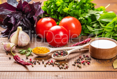 Raw vegetables, basil and spices on the wood table