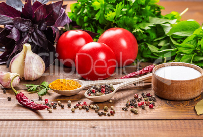 Raw vegetables, basil and spices on the wood table