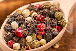 Pepper seeds in wooden spoon on wood table