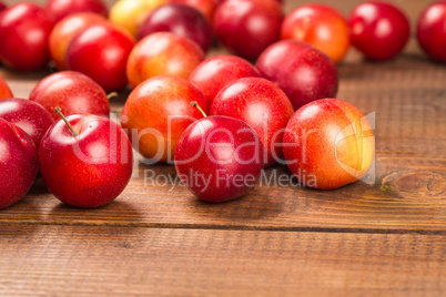 Sweet plums on wooden background