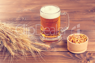 Oktoberfest Beer Mug and traditional German pretzels with wheat cones on the wood  table